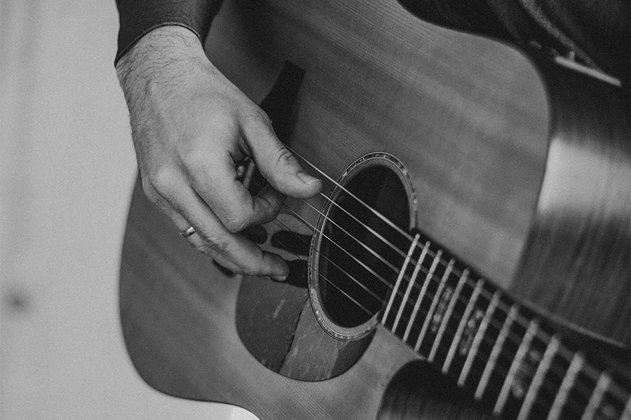 Guitar detail with playing hand